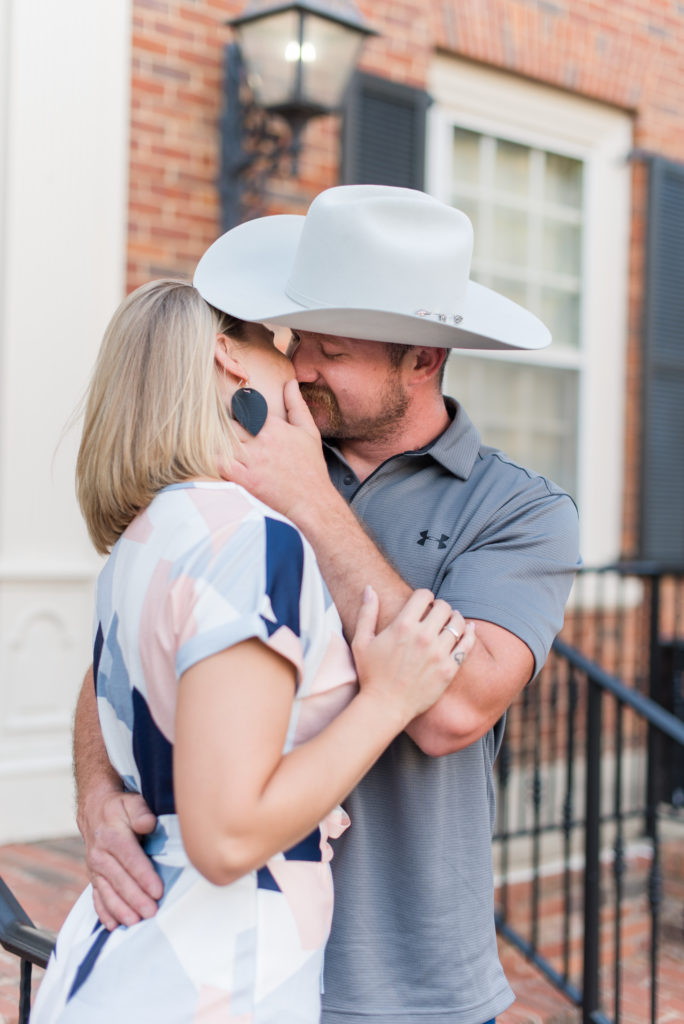 Downtown Lagrange Ga Couples engagement photo session with cowboy hat kissing