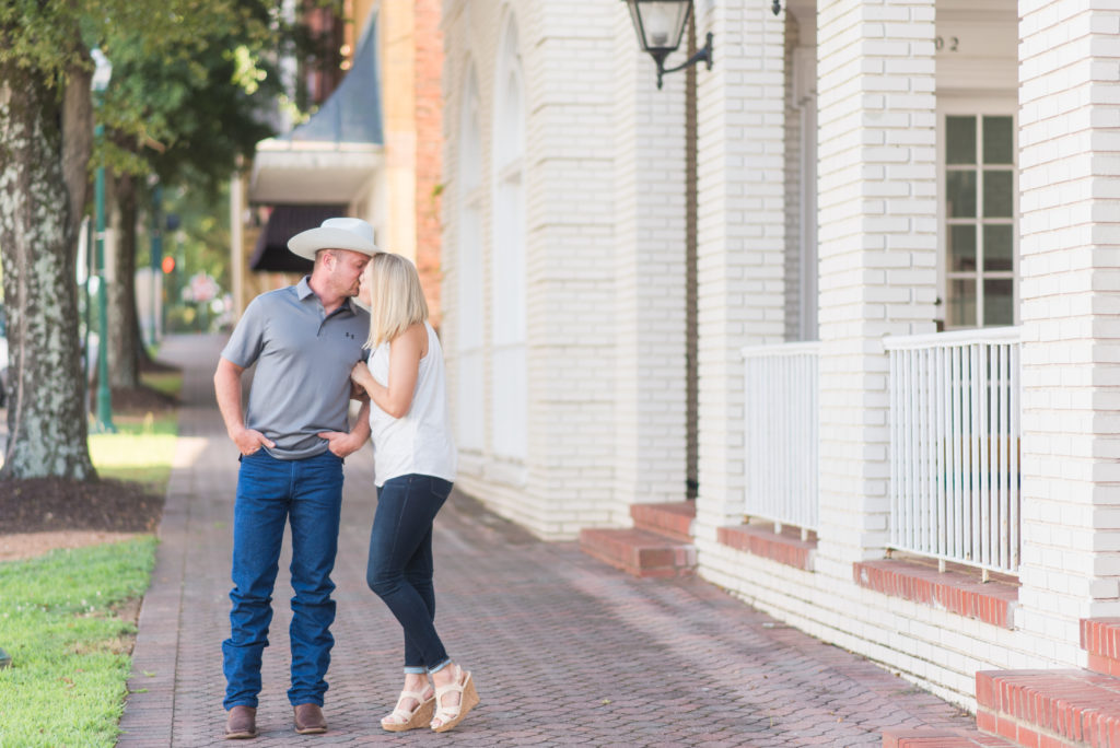 Couples engagement photo session with cowboy hat