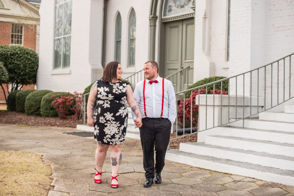 Engaged couple sitting on steps in Newnan GA