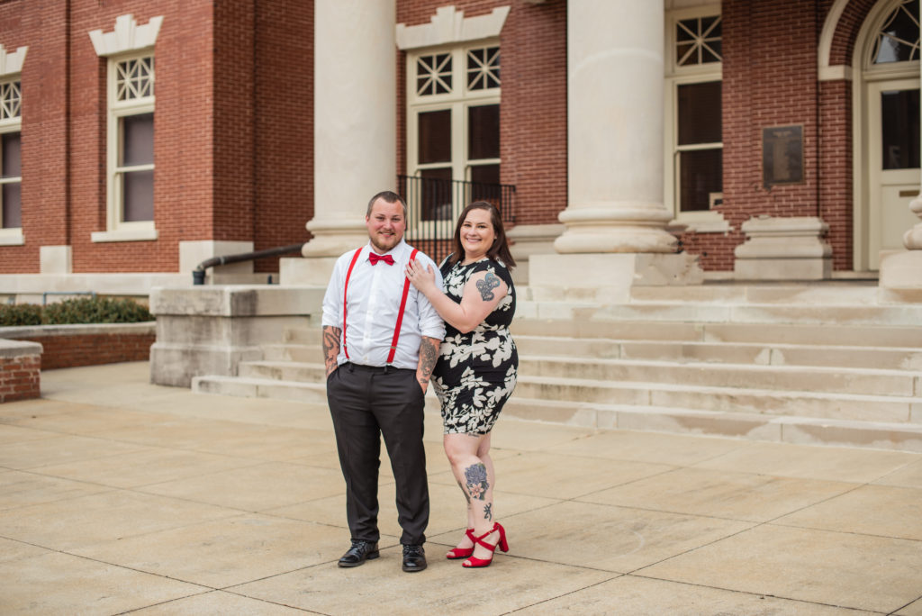 Engaged couple in front of courthouse in Newnan GA